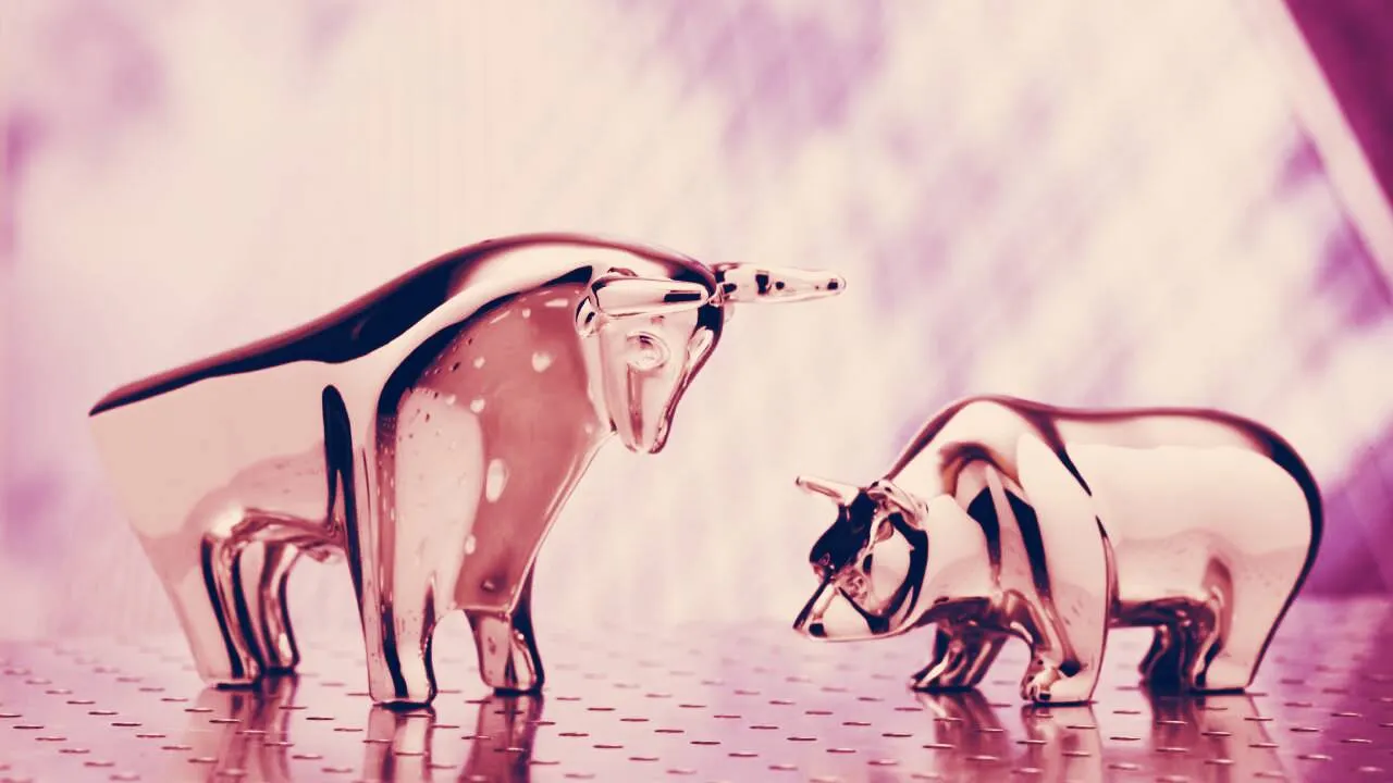 A bull looks down at a bear. Image: Shutterstock.