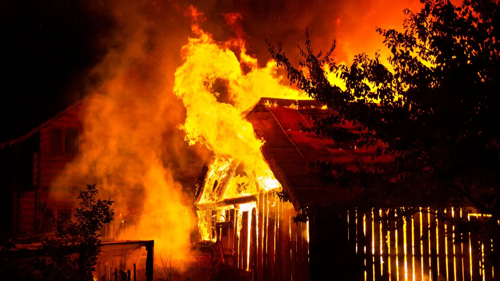 Wooden house or barn burning on fire at night. Image: Shutterstock