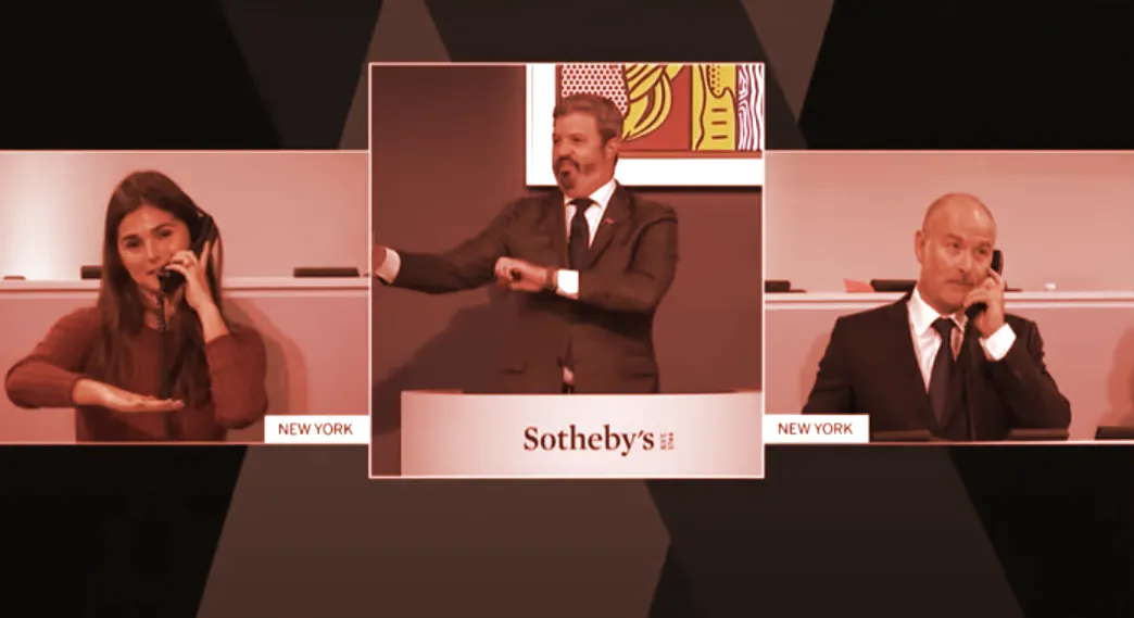 Sotheby's head of fine art sales Brooke Lampley (L) and Sotheby's head of private sales David Schrader (far right) take phone bids during the auctioning of a rare copy of the US Constitution on November 18, 2021. Schrader, it turned out, was representing the DAO.