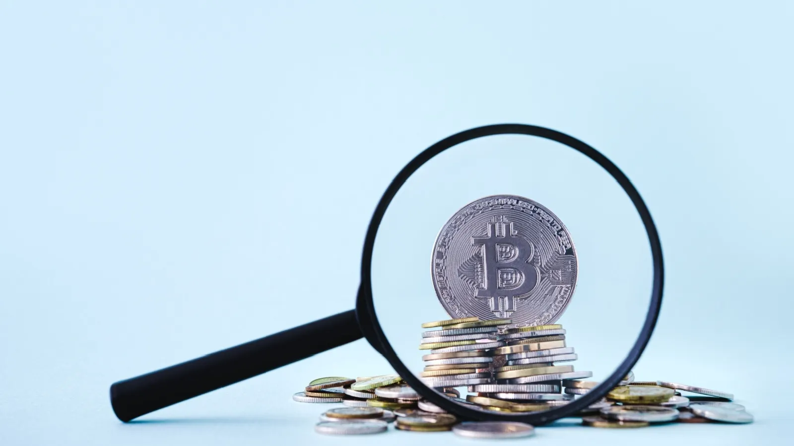 Bitcoin behind a magnifying glass. Source: Shutterstock